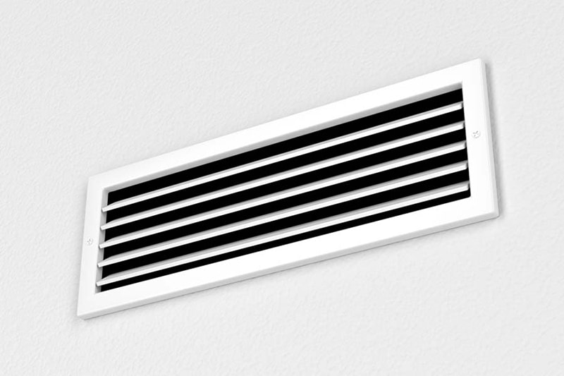 White air conditioning vent in a white wall. Why Is My AC Blowing Hot Air?