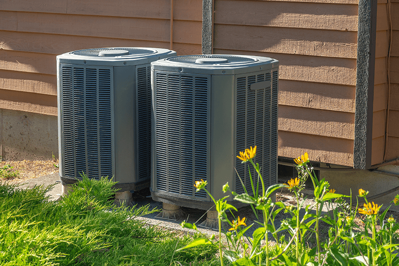 Purchasing the Right Air Conditioner - Two Air Conditioning Units Outside.